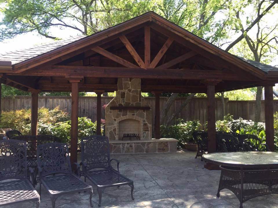 pergola and outdoor fireplace in yard